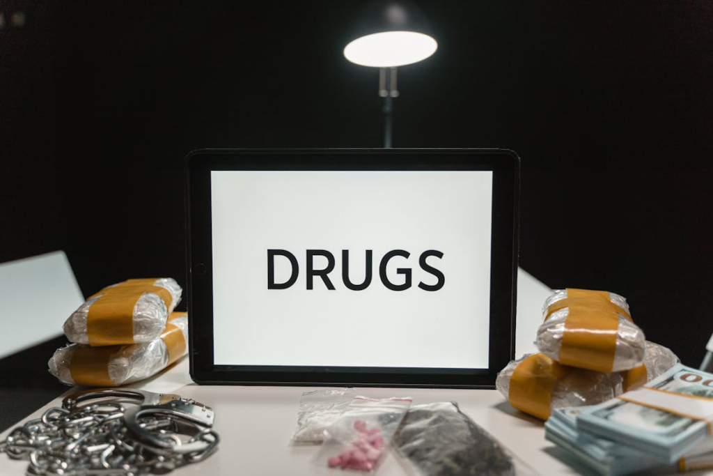 Controlled substances on the table with a board saying “drugs”