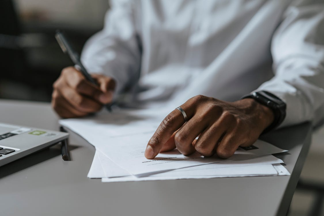 An image of a person writing on paper 