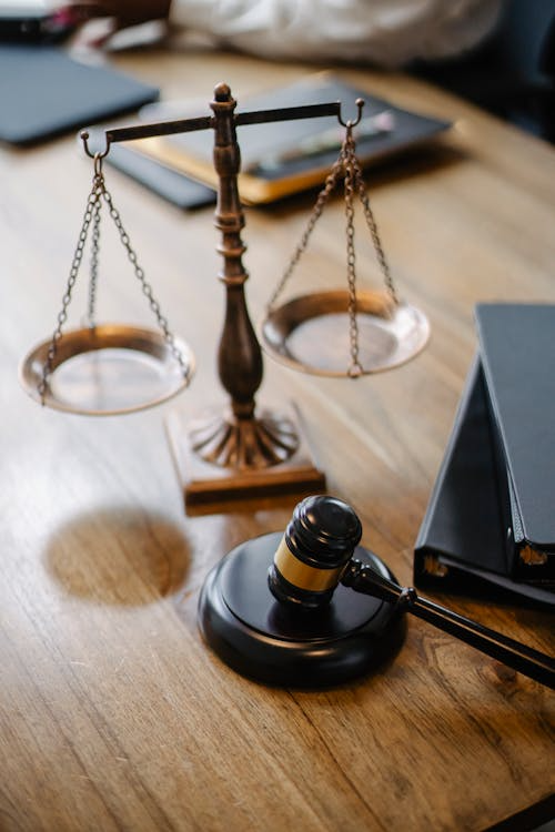 Justice scale with gavel on a desk