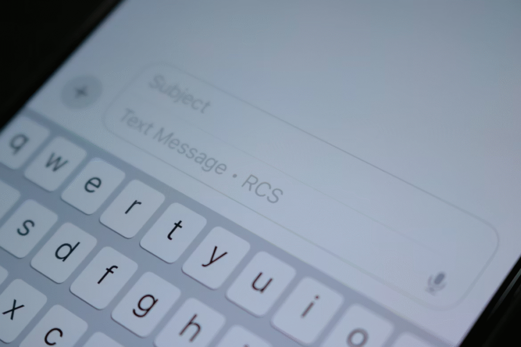 Close-up of a smartphone with a keyboard visible