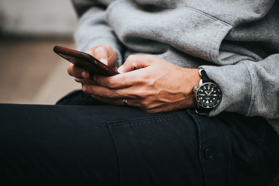 Person wearing a wristwatch and looking at their hand
