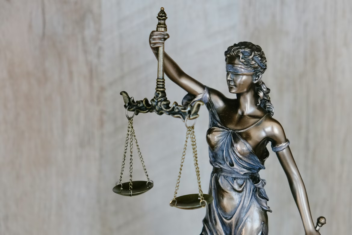 Woman holding a statue representing justice